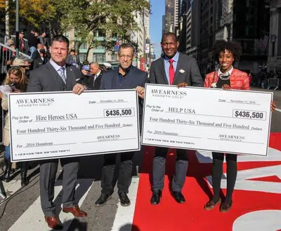 Kenneth Cole, Chairman and Chief Creative Officer of Kenneth Cole Productions, awarded Brian Stann, President and CEO of Hire Heroes USA and Marine combat veteran, and HELP USA's Jahmila Vincent, Program Director at HELP Hollis Garden Apartments, and Linson Baily Alexander, Executive Director of HELP USA's National Supportive Services for Veteran Families, with their donation checks.
